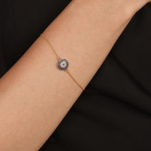 Load image into Gallery viewer, Elegant model hand showcasing the intricate details of our Gold Plated Silver Evil Eye Blue Sapphire Protection Bracelet Evil Eye Guardian Bracelet