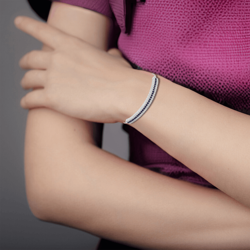 Elegant model hand showcasing the intricate details of our silver bracelet silver bracelet bracelet for women white topaz bracelet cuff bracelet gemstone cuff gemstone bracelet sapphire bracelet blue bracelet natural sapphire blue sapphire blue bridesmaid gift blue cuff bracelet