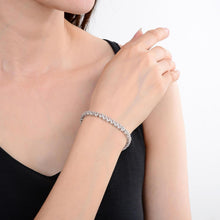 Load image into Gallery viewer, legant model hand showcasing the intricate details of our silver bracelet Petite Sterling Silver White Topaz Bracelet, $ 150 - 200, White Topaz, Round, White, 925 Sterling Silver, Tennis