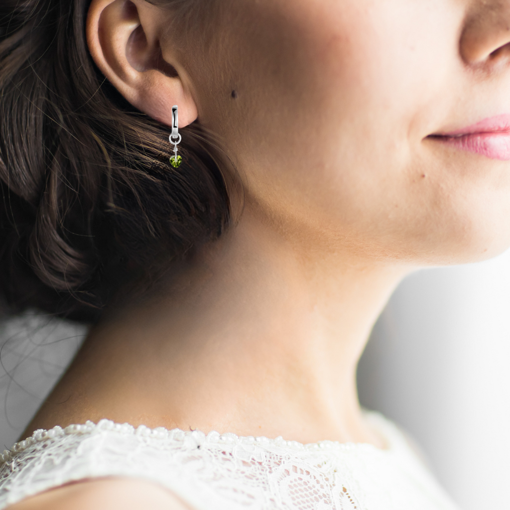 model showcasing  Evil Eye Peridot Earrings