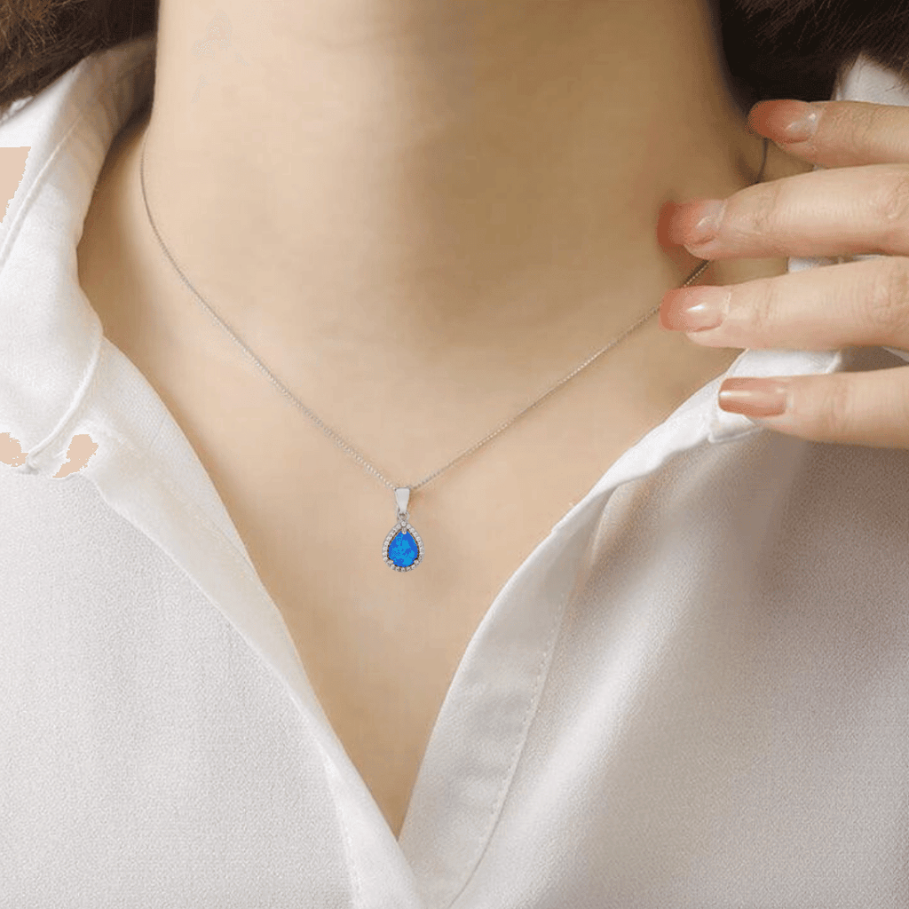 model showcasing  Lab Grown Blue Opal Teardrop Pendant with CZ Accents October Birthstone Gift Blue Pendant Anniversary Gift