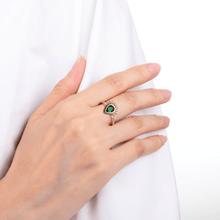 Load image into Gallery viewer, Model wearing chrome diopside ring, deep green gemstone ring, pear shape gemstone ring design