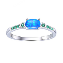 Load image into Gallery viewer, Blue Opal Oval Three Stone Ring, Lab grown oval cabochon opal ring, opal and emerald ring, affordable opal ring